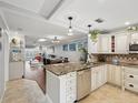 Open kitchen with island, granite countertops and stainless steel appliances at 3259 Hilary Cir # 1C, Palm Harbor, FL 34684