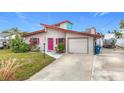 Mid-century modern home with pink door, attached garage and boat parking at 3265 Gardenia Dr, Hernando Beach, FL 34607