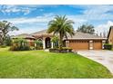 Spacious home with a three-car garage and manicured lawn at 3414 Graycliff Ln, Brandon, FL 33511