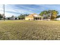 Large backyard with house and screened patio visible in the background at 4332 Lamson Ave, Spring Hill, FL 34608
