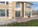 Elegant front entrance with dark-gray door and decorative stone pathway at 4332 Lamson Ave, Spring Hill, FL 34608