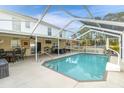 Inviting screened pool area with a spacious patio and seating at 4332 Lamson Ave, Spring Hill, FL 34608
