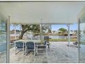 Covered patio with table and chairs, overlooking the canal at 4430 Floramar Ter, New Port Richey, FL 34652