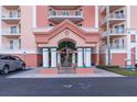 Condo building entrance with columns, fountain, and a covered walkway at 4516 Seagull Dr # 417, New Port Richey, FL 34652