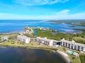 Aerial view of waterfront condo building with parking and pool at 4620 Bay Blvd # 1158, Port Richey, FL 34668