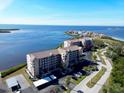 Aerial view of waterfront condo building with parking at 4620 Bay Blvd # 1158, Port Richey, FL 34668