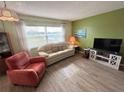 Living room with light colored sofa and wood-look floors at 5434 Chad Pl # 20, New Port Richey, FL 34652