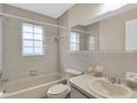 Clean bathroom with a bathtub, toilet, and updated vanity at 6033 Wilds Dr # B07, New Port Richey, FL 34653