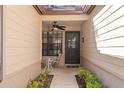 Front entry with ceiling fan, small sitting area, and side yard view at 6663 Water Oak Ct, Spring Hill, FL 34606