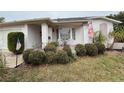 Front porch with seating area and lush greenery at 8111 Merrimac Dr, Port Richey, FL 34668