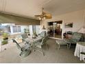 Relaxing screened porch with seating and ceiling fan at 8111 Merrimac Dr, Port Richey, FL 34668