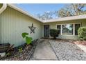 Front entrance with walkway, landscaping, and a star-shaped decoration at 8446 Braganza St, Spring Hill, FL 34608