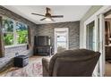 Relaxing sunroom with a comfortable chair and TV at 8446 Braganza St, Spring Hill, FL 34608