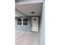 Newly renovated front door with a white door and brick columns at 8703 Robilina Rd, Port Richey, FL 34668