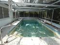 Enclosed inground pool needing some TLC at 9241 Cochise Ln, Port Richey, FL 34668