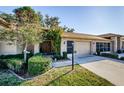 Brick house exterior with a two-car garage, walkway, and landscaping at 9338 Clearmeadow Ln, New Port Richey, FL 34655