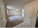 Spacious living room with carpeted floors and a view into other rooms at 13017 Willoughby Ln, Hudson, FL 34667