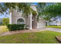 Two-story house with landscaping and a partial view of the driveway at 13468 Haverhill Dr, Spring Hill, FL 34609