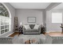 Living room featuring a gray sectional sofa and large window at 13468 Haverhill Dr, Spring Hill, FL 34609