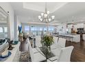 Elegant dining area with glass table, white chairs, and waterfront views at 2013 Gulfview Dr, Holiday, FL 34691