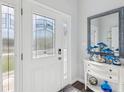Bright entryway with white door, stained-glass accents, and decorative console table at 2013 Gulfview Dr, Holiday, FL 34691