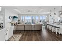 Spacious living room with hardwood floors, sectional sofa, and stunning water views at 2013 Gulfview Dr, Holiday, FL 34691