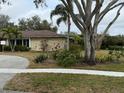 House exterior showcasing landscaping and a large tree at 3039 Sandpiper Ct, Clearwater, FL 33762