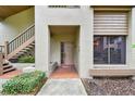 Inviting condo entrance with brick walkway, stairs, and landscaping at 3053 Landmark Blvd # 1104, Palm Harbor, FL 34684