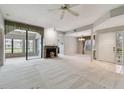 Spacious living room with carpet, fireplace, and access to a sunroom at 3053 Landmark Blvd # 1104, Palm Harbor, FL 34684