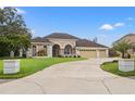 Beautiful home with a large driveway and mature landscaping at 4412 Lake In The Woods Dr, Spring Hill, FL 34607
