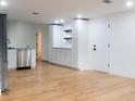 White kitchen cabinets, granite countertops and stainless steel dishwasher at 4852 Capron St, New Port Richey, FL 34653