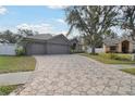 Home with three-car garage and patterned driveway at 609 Salt Lake Dr, Tarpon Springs, FL 34689