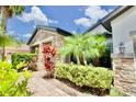 House exterior with stone accents and lush landscaping at 8424 Bluevine Sky Dr, Land O Lakes, FL 34637