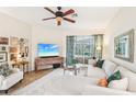 Bright and airy living room with comfortable seating and a large TV at 8831 Bel Meadow Way, Trinity, FL 34655