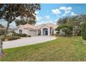 One-story house with a two-car garage and manicured lawn at 9090 Alexandria Dr, Weeki Wachee, FL 34613
