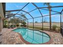 Relaxing screened pool and spa area with brick pavers at 9323 Bella Vita Cir, Land O Lakes, FL 34637