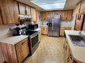 Spacious kitchen with stainless steel appliances and wood cabinets at 10185 Horizon Dr, Spring Hill, FL 34608
