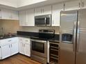 Updated kitchen with stainless steel appliances and granite countertops at 108 Lakeside Dr, Oldsmar, FL 34677