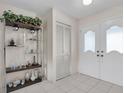 Bright entryway with white doors and tiled floor at 11030 Linkside Dr # 11030, Port Richey, FL 34668