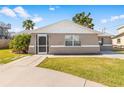 Quaint house with a landscaped lawn and walkway at 13637 Lagoon Dr, Hudson, FL 34667