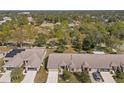 Community overview featuring numerous houses with tile roofs and lush green landscaping at 1392 Summerwood Ct, Spring Hill, FL 34606