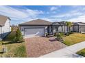 Single story home with covered porch and paver driveway at 18879 Sailors Delight Pass, Land O Lakes, FL 34638