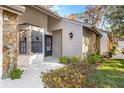 The front entrance of the villa, highlighting stonework and landscaping at 6611 Sovereign Way, Spring Hill, FL 34606