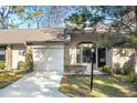 Attractive exterior of a villa with a garage and well-maintained landscaping at 6611 Sovereign Way, Spring Hill, FL 34606