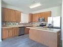 Kitchen with wood cabinets, stainless steel appliances, and an island at 9142 Bell Rock Pl, Land O Lakes, FL 34638