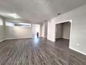 Spacious living area with grey wood-look floors at 9142 Bell Rock Pl, Land O Lakes, FL 34638