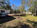 Wooden deck with railing, overlooking backyard at 9741 Star Trl, New Port Richey, FL 34654
