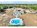Aerial view of a home with pool and expansive lot at 10030 Orchard Way, Spring Hill, FL 34608
