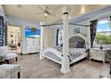 Main bedroom with a large four poster bed and plenty of natural light at 10030 Orchard Way, Spring Hill, FL 34608