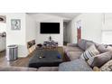 Living room features gray couch, large TV, and wood-look floors at 10147 Spring Hill Dr, Spring Hill, FL 34608